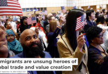 Carmindo Alves Barbosa Amado, originally of Cape Verde, waves the American flag after being sworn in during a naturalization ceremony in Boston in April 2024. Danielle Parhizkaran/The Boston Globe via Getty Images